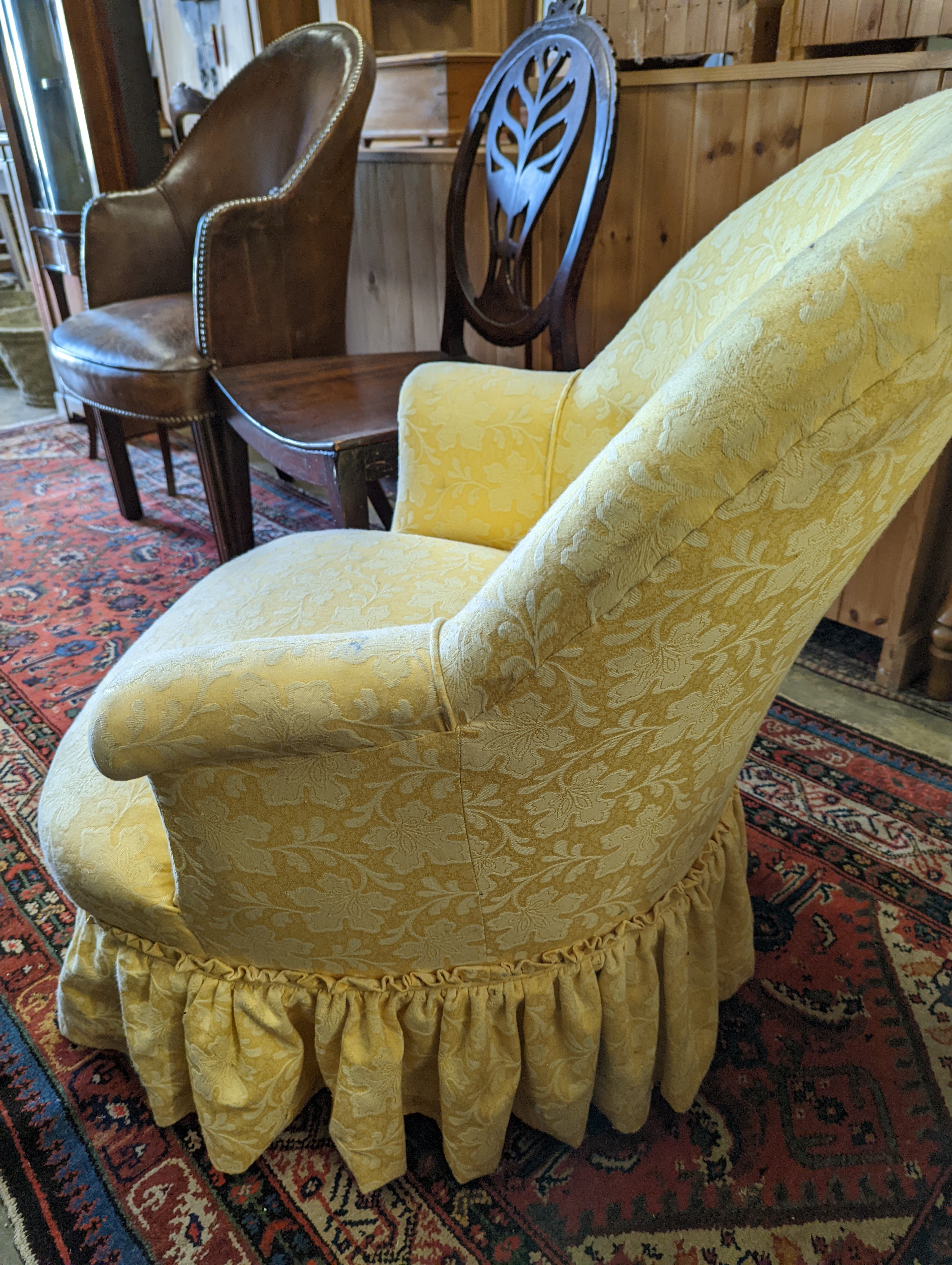 A brown leather upholstered desk chair, a mahogany hall chair and two upholstered armchairs